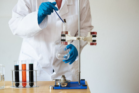 Scientist Testing Liquids with Apparatus by RF Studio